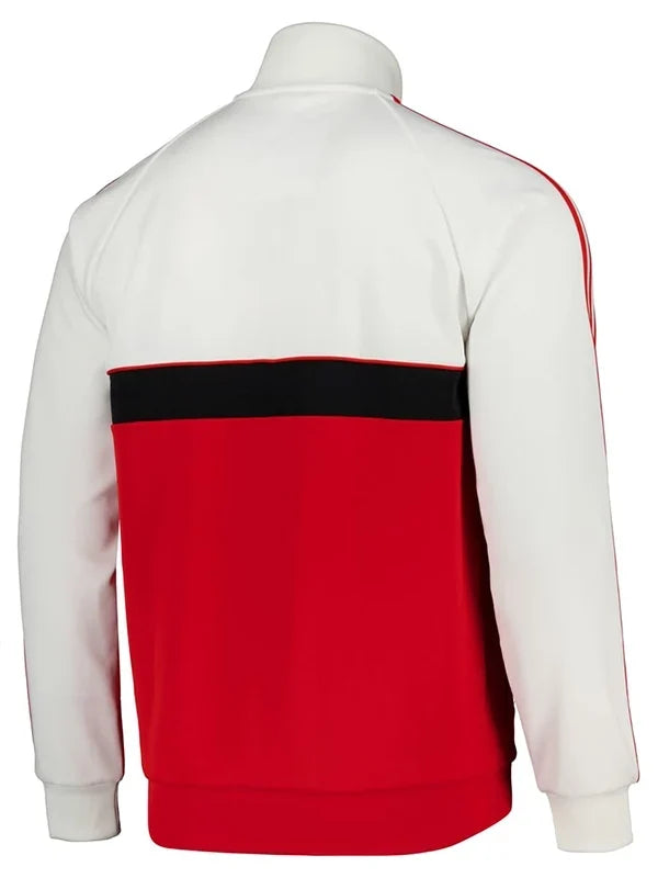 A white and red colorblock track jacket shown from the back, featuring a black horizontal stripe across the upper back and red stripes running down the sleeves.