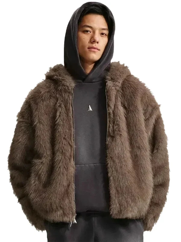 A model wearing a brown faux fur zip-up jacket over a dark gray hoodie and sweatpants, photographed against a solid light gray background.