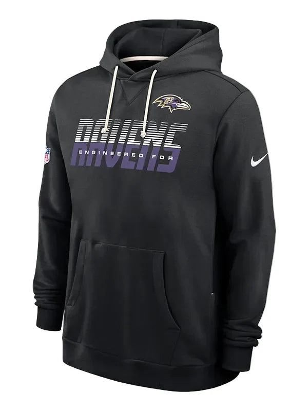 A black Nike Baltimore Ravens pullover hoodie featuring the team logo on the left chest, a large 'RAVENS' graphic with 'ENGINEERED FOR' underneath, and a white Nike swoosh on the right sleeve, shown against a light gray background.
