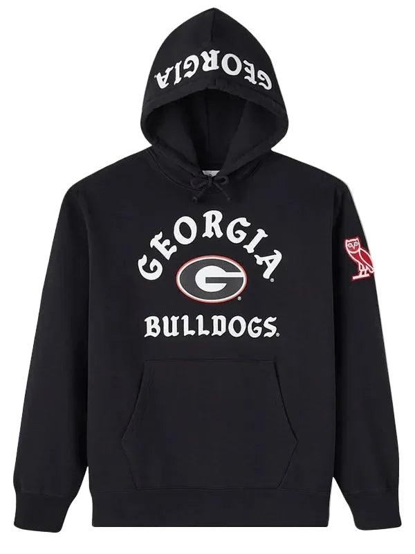 A black pullover hoodie featuring the Georgia Bulldogs logo on the front, with 'GEORGIA BULLDOGS' printed in white on the chest and hood, and a red owl logo on the sleeve.