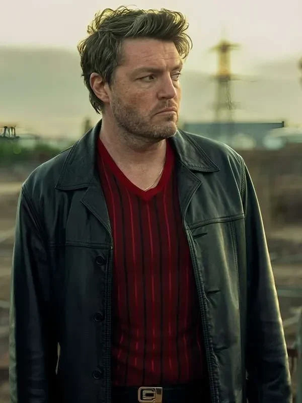 Man wearing a green jacket over a red shirt with a blurred background