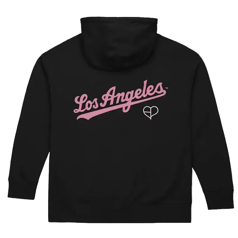 A black zip-up hoodie shown from the back, featuring 'Los Angeles' in pink script across the upper back with a small white broken-heart graphic underneath.